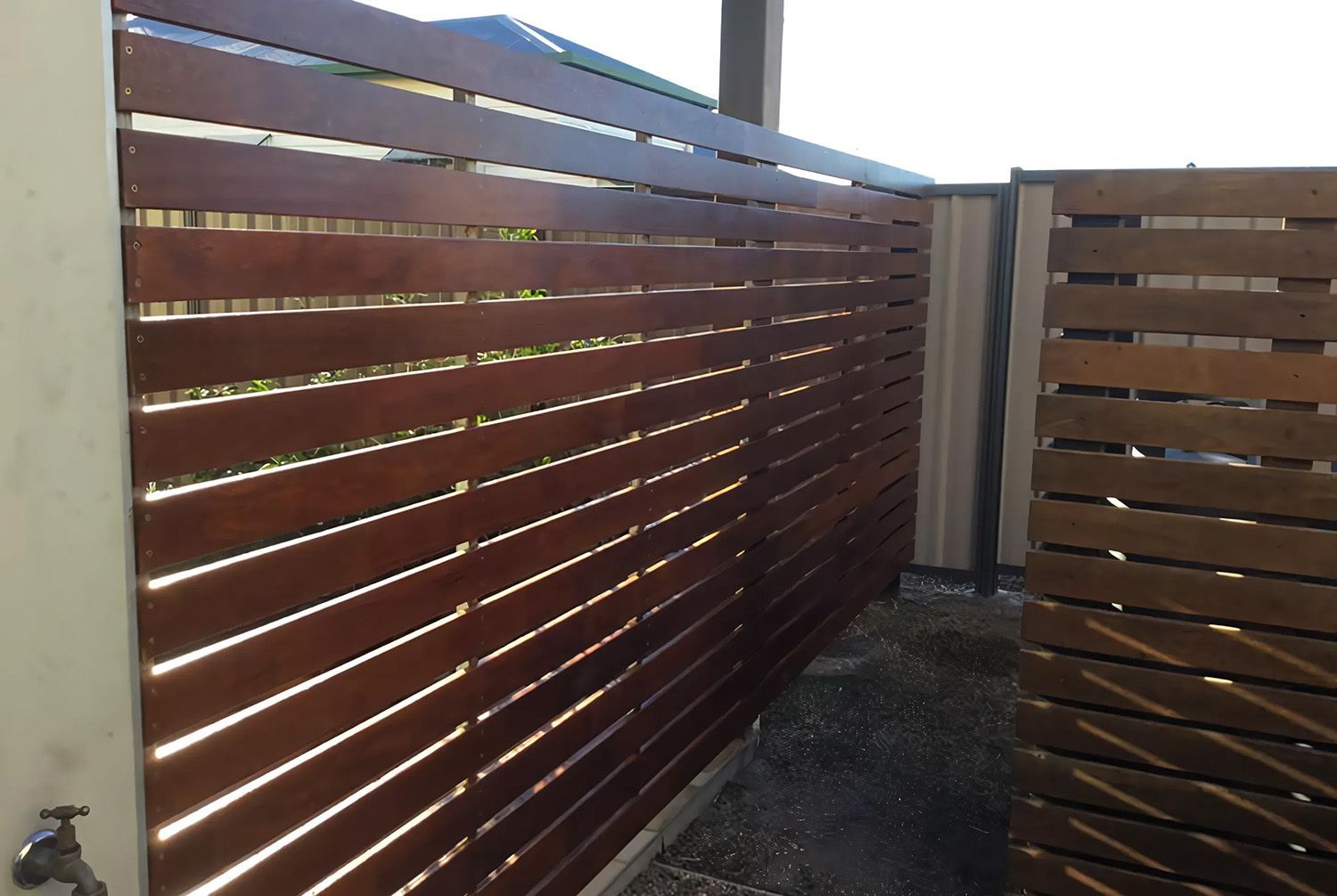 Brown Wooden Horizontal Slat Fence With Gaps Designed For Visual Privacy