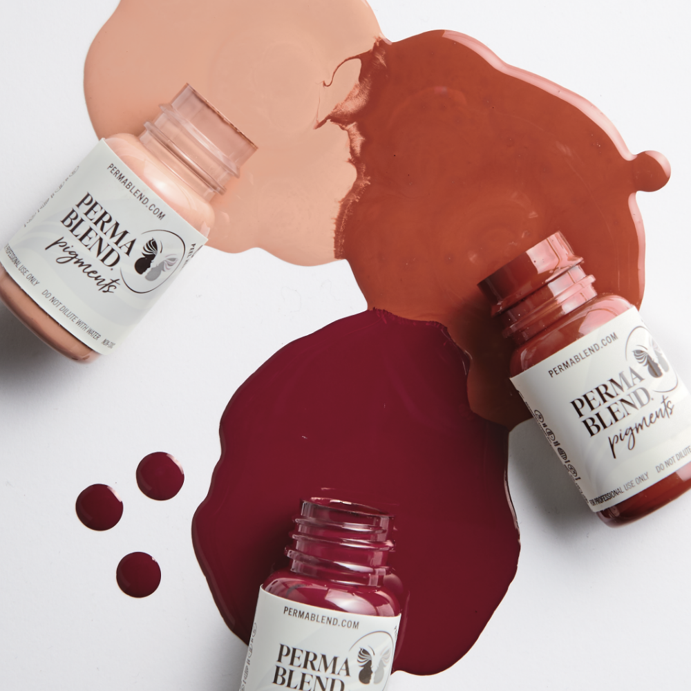 Cosmetic nail polish bottles with spilled blush, burgundy, and terracotta shades on a pale background