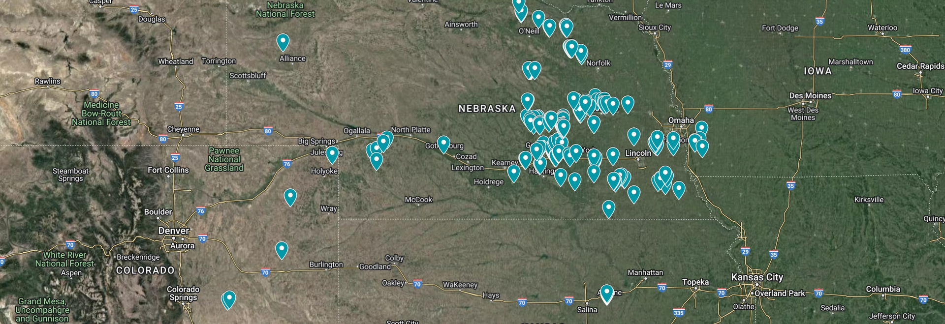 Satellite map with many cyan markers clustered across a green-brown landscape.