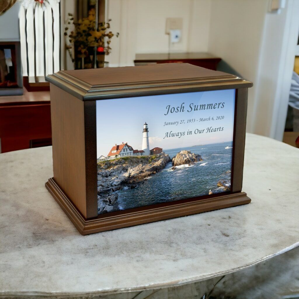 Wooden memorial urn with lighthouse photo and engraved name on a stone table.