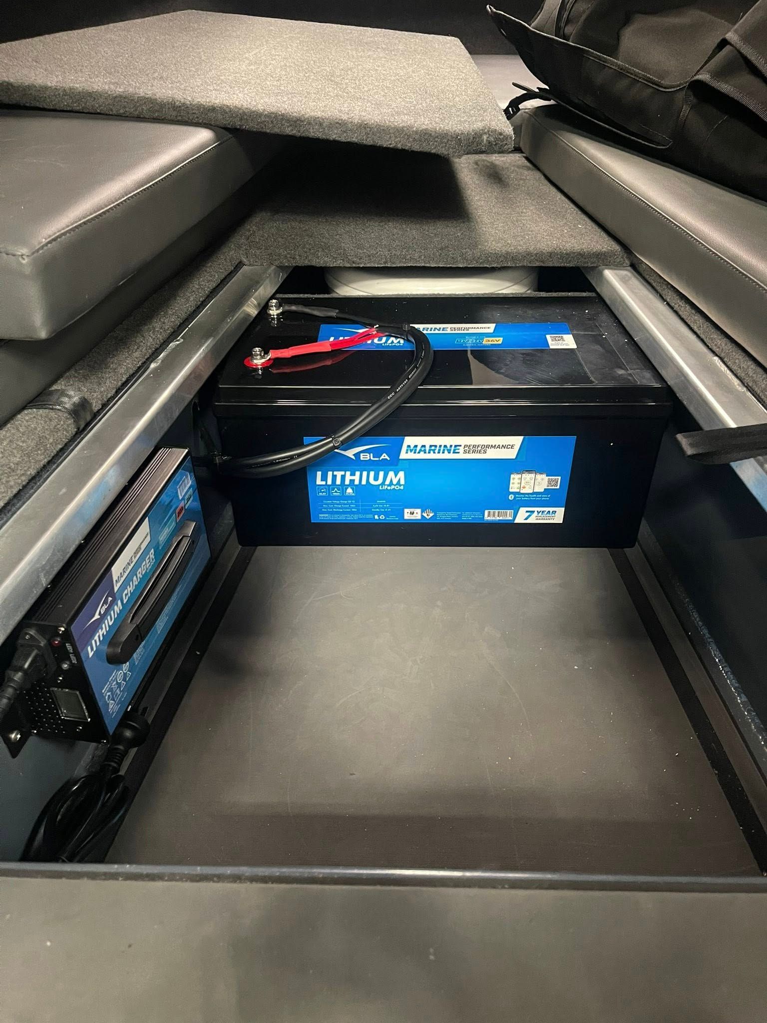 A Black Lithium Battery and a Blue Charger Installed — Hastings Mobile Marine Services In Wauchope, NSW
