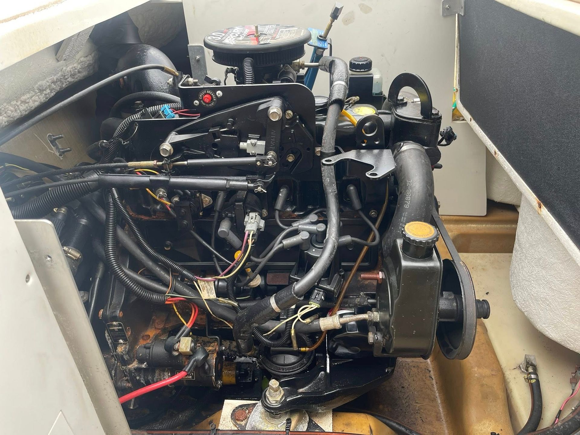 A Black Marine Engine Inside a Boat's Engine Compartment — Hastings Mobile Marine Services In Wauchope, NSW
