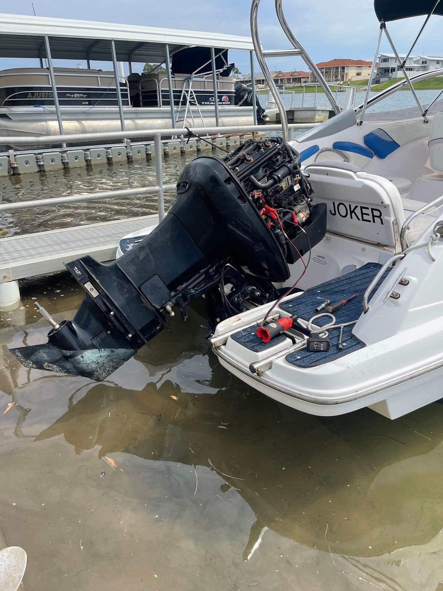 A Boat With a Large, Black Outboard Motor Partially Submerged in Water — Hastings Mobile Marine Services In Wauchope, NSW