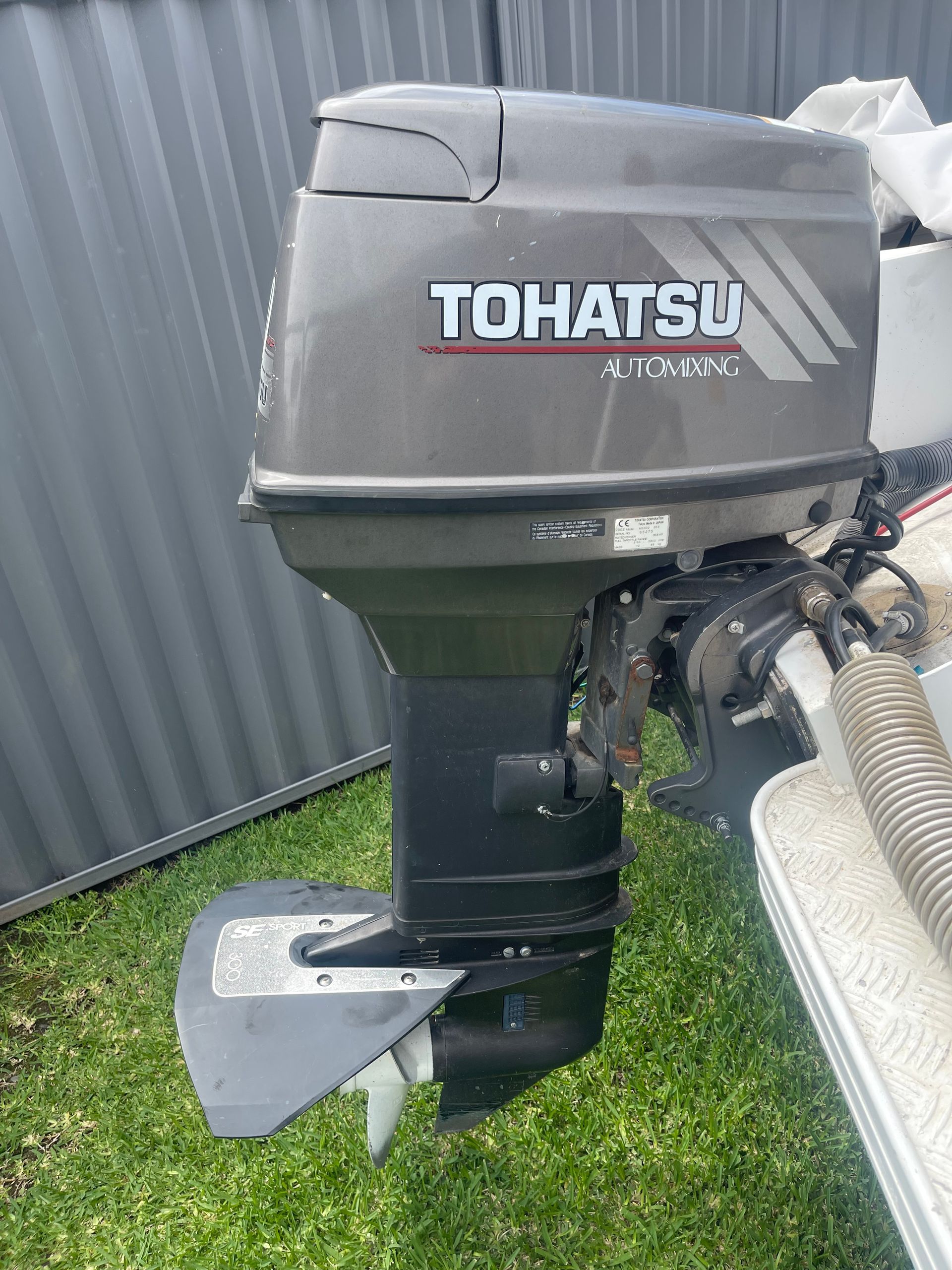 A Grey Tohatsu Outboard Boat Motor Mounted on a Boat Transom — Hastings Mobile Marine Services In Kempsey, NSW