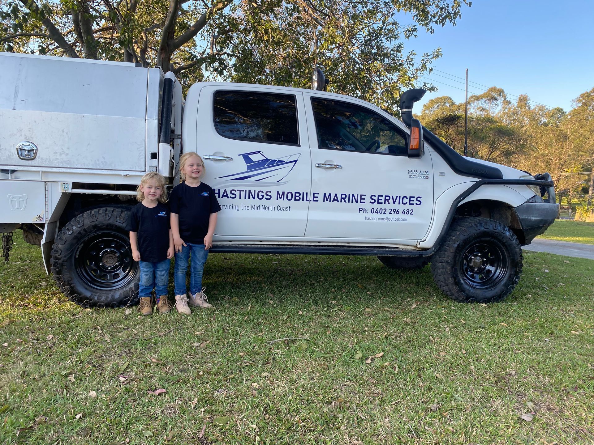 Two Children Stand Beside a White Work Truck — Hastings Mobile Marine Services In Wauchope, NSW