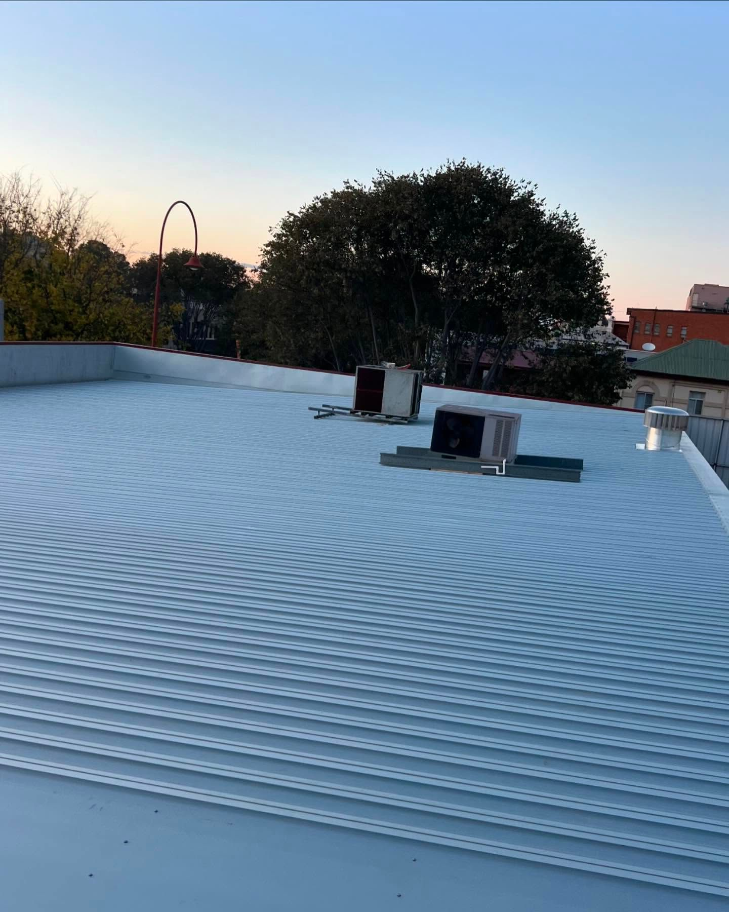 White Corrugated Metal Rooftop With Hvac Units — Ace Metal Roofing in Waterview Heights, NSW