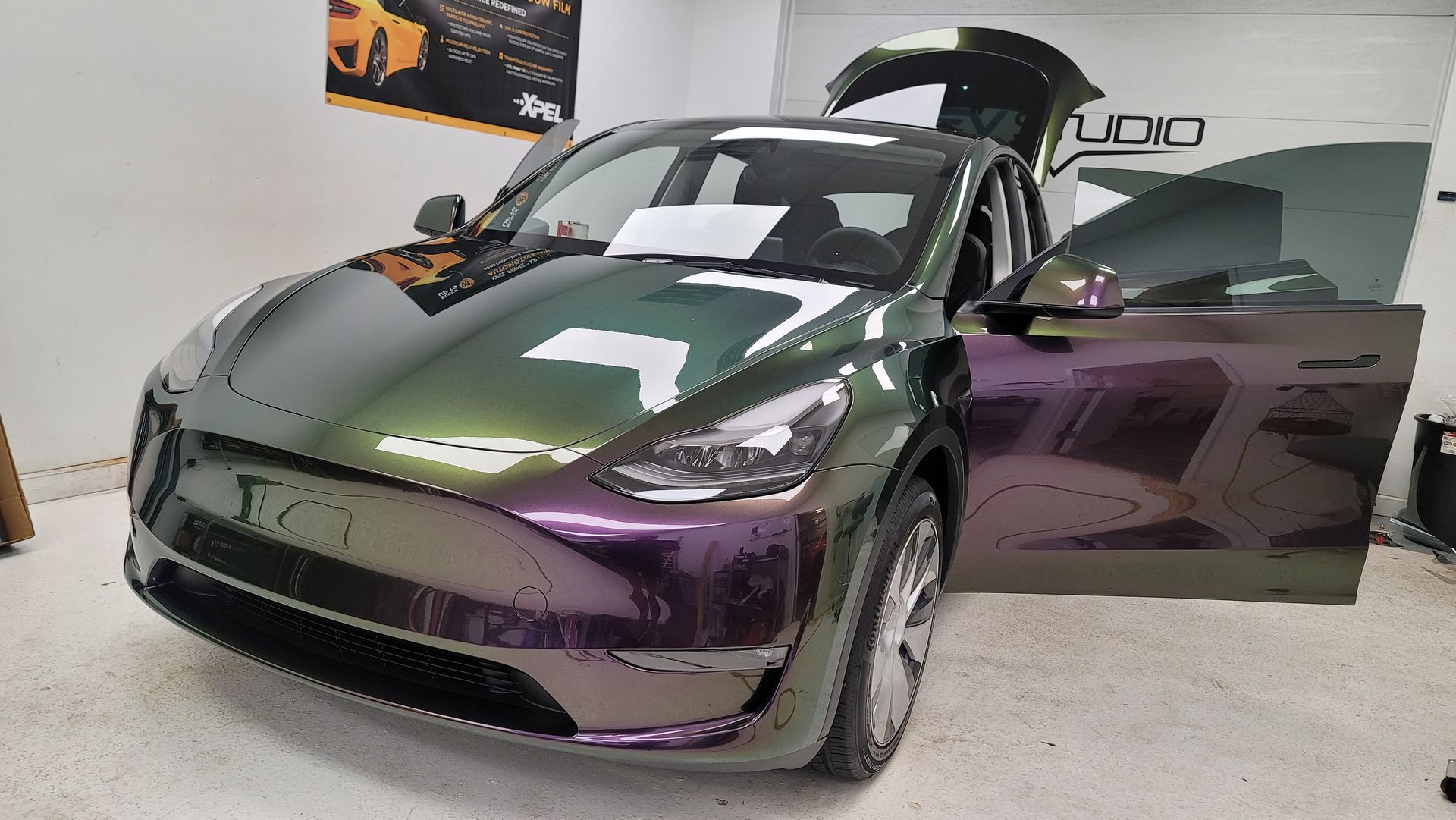 A black tesla model s is parked in front of a building.