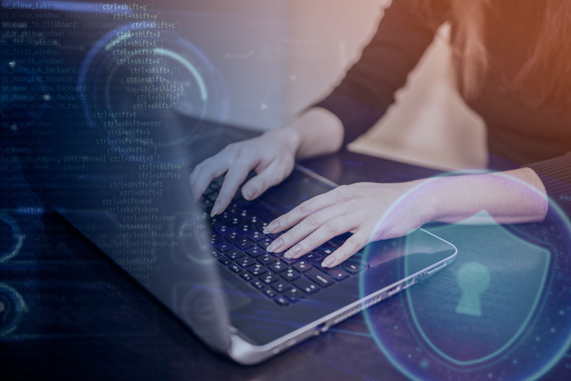 Person typing on a laptop with digital code and a shield icon overlay, symbolizing cybersecurity and data protection.