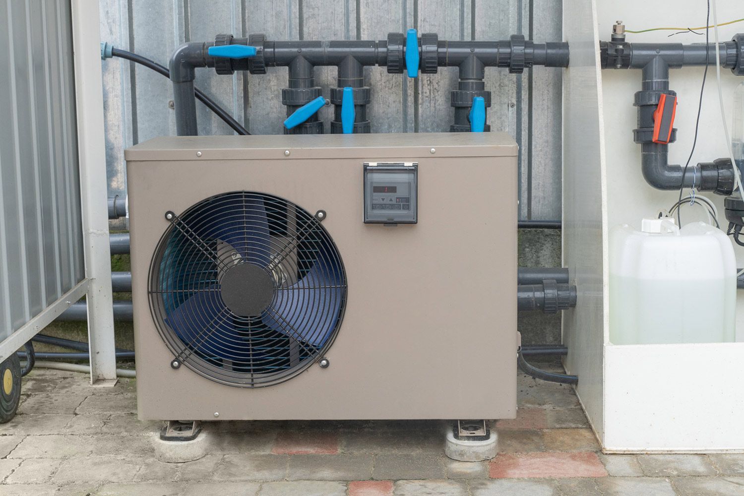 Outdoor heat pump with fan in backyard