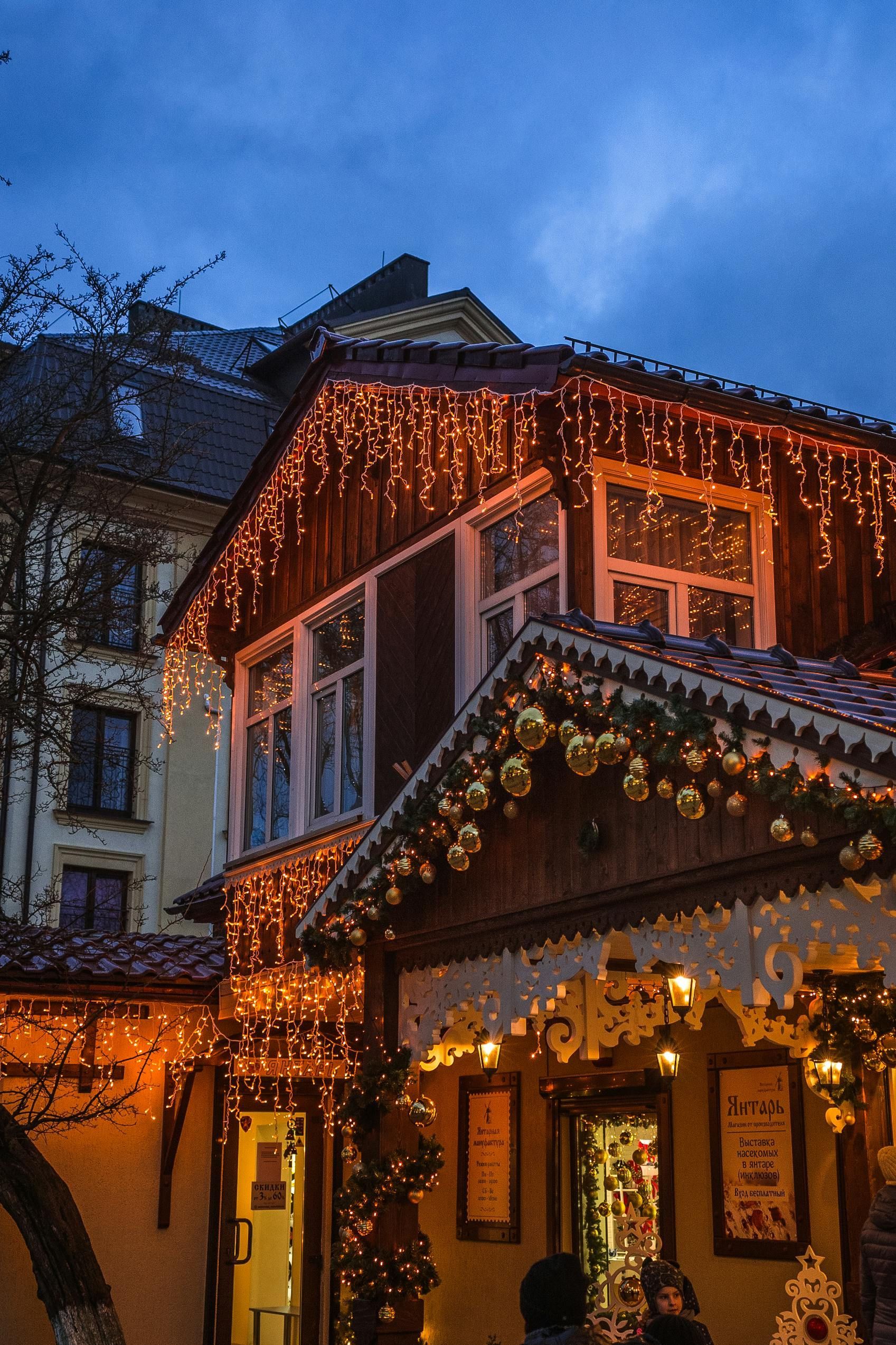 A building with christmas lights on it is lit up at night