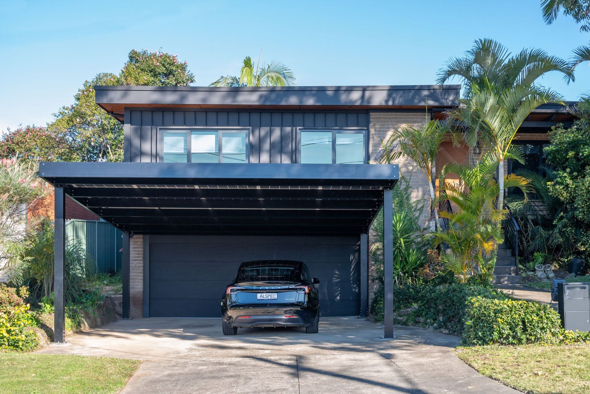 Black Car Parked Under a Modern Carport — Mid North Coast Solar Carports in Coffs Harbour, NSW