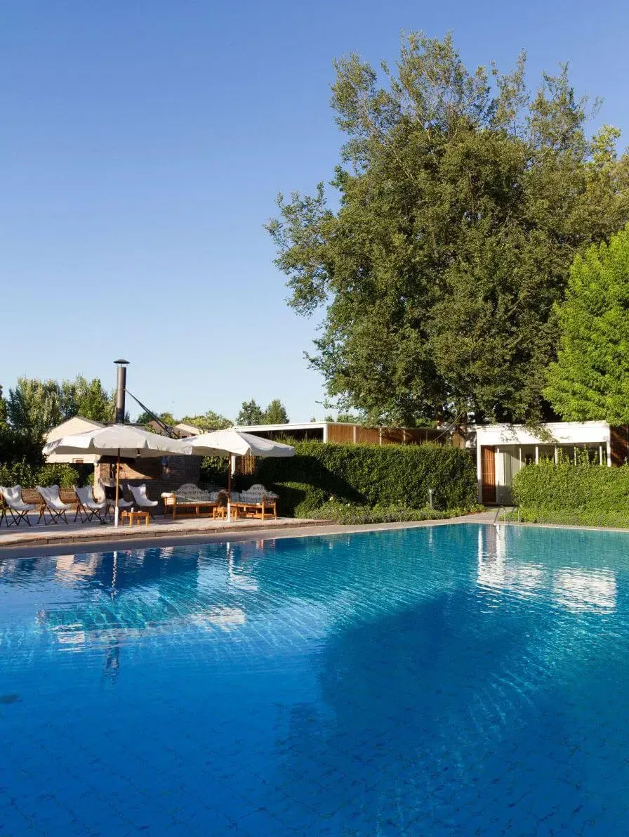 A photo of an in-ground pool on a clear day