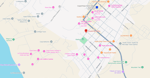 City map with roads, place labels, and colored route markers near a coastline