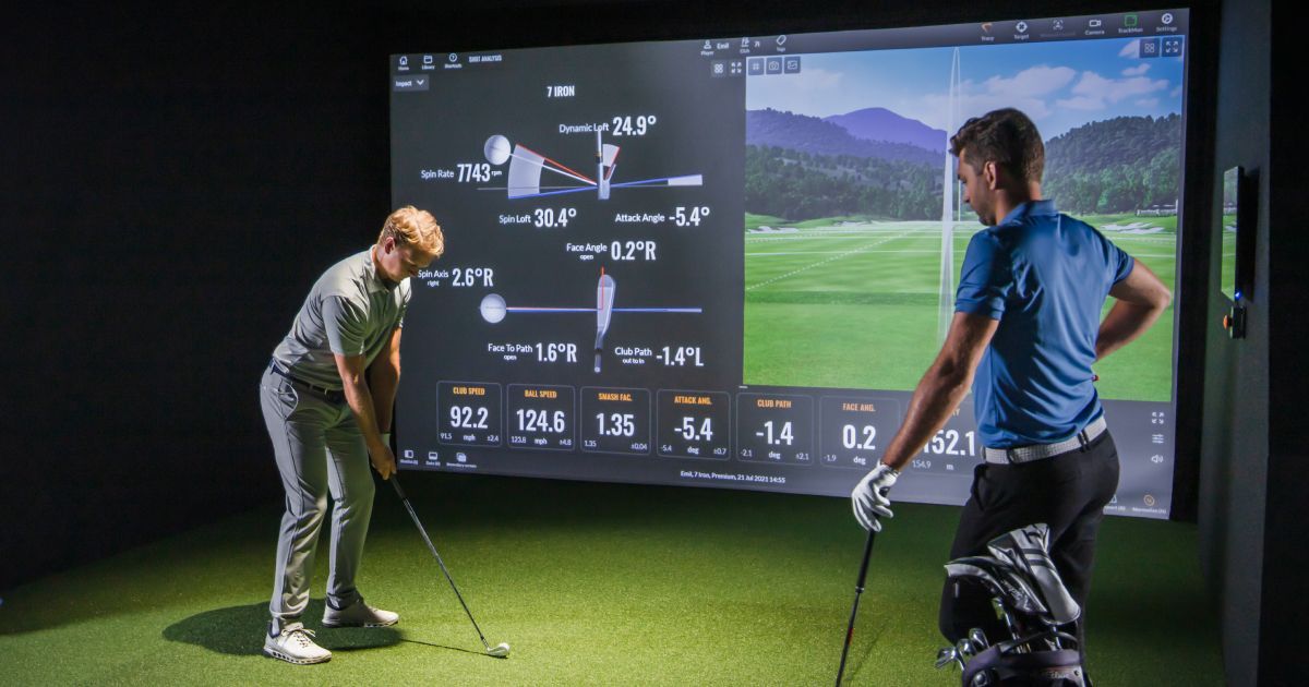 Golfer using TrackMan indoor performance software for swing analysis