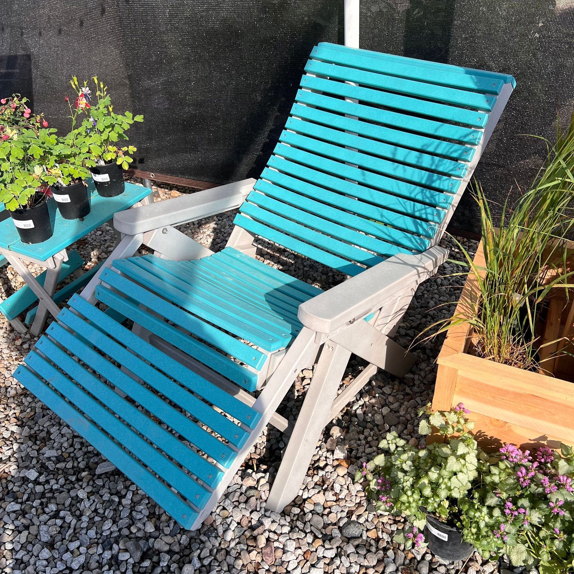 A blue and white chair is sitting on a pile of gravel