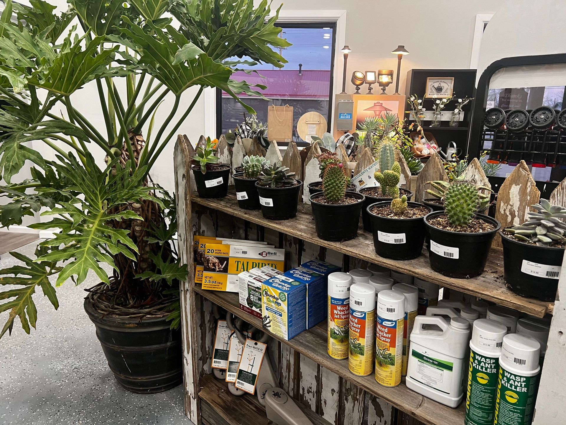 A shelf filled with potted plants and bottles of fertilizer.