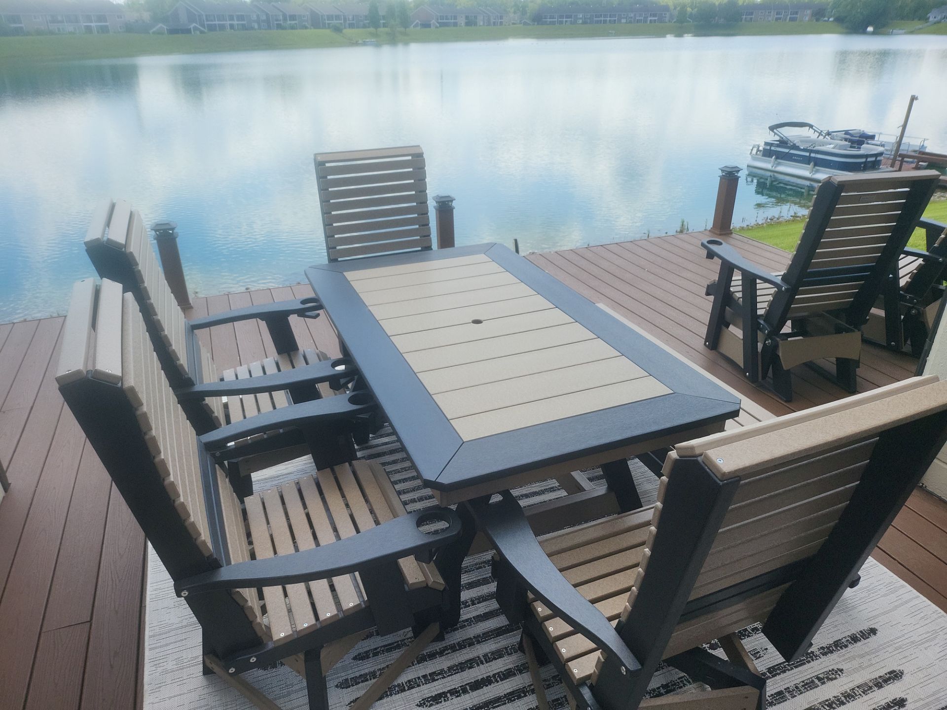 A table and chairs on a dock overlooking a lake