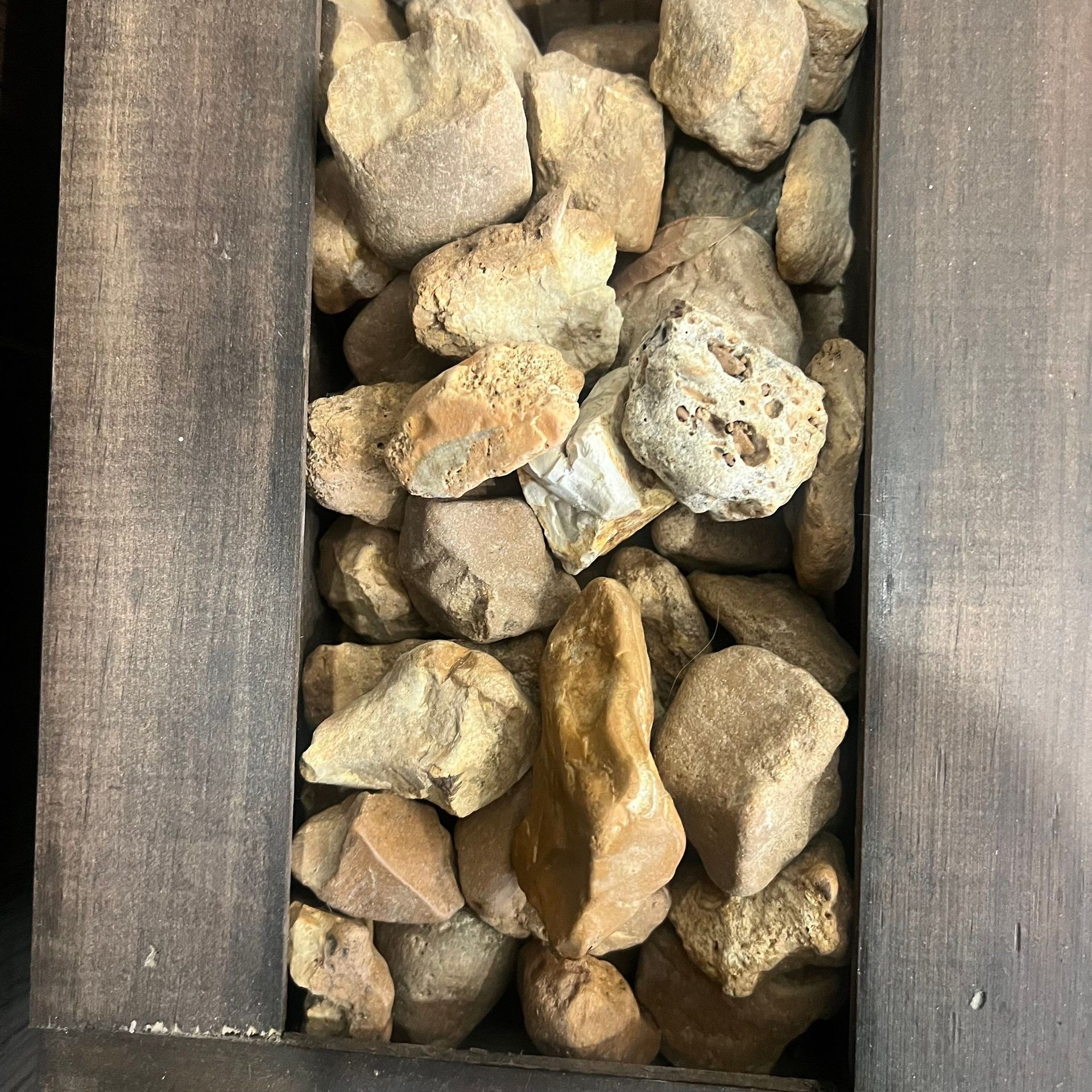 A pile of rocks in a wooden box