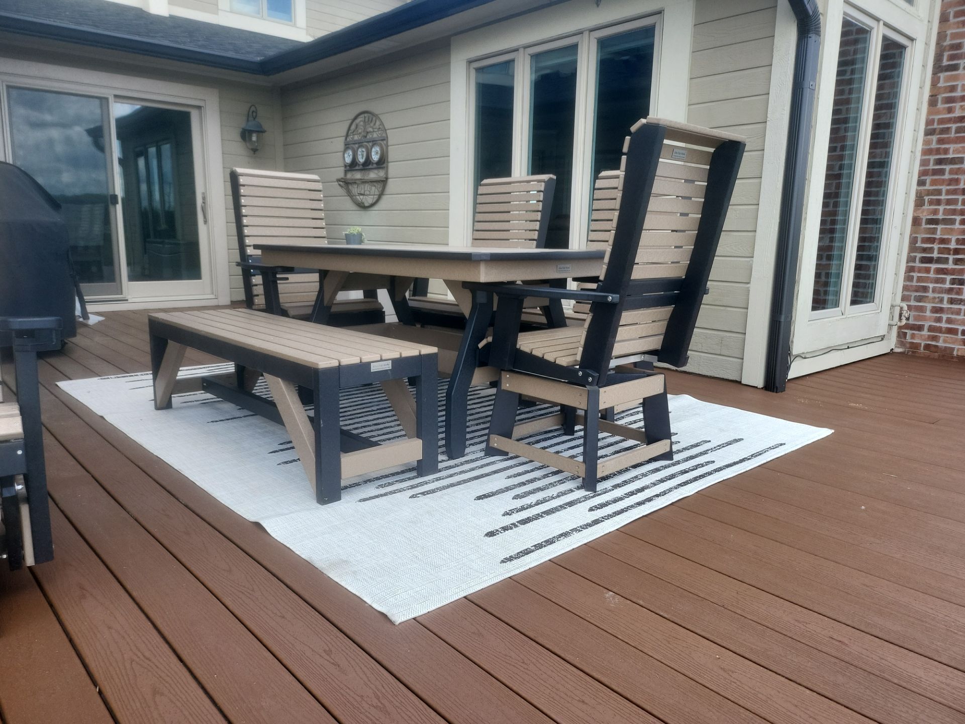 A wooden deck with a table and chairs on it