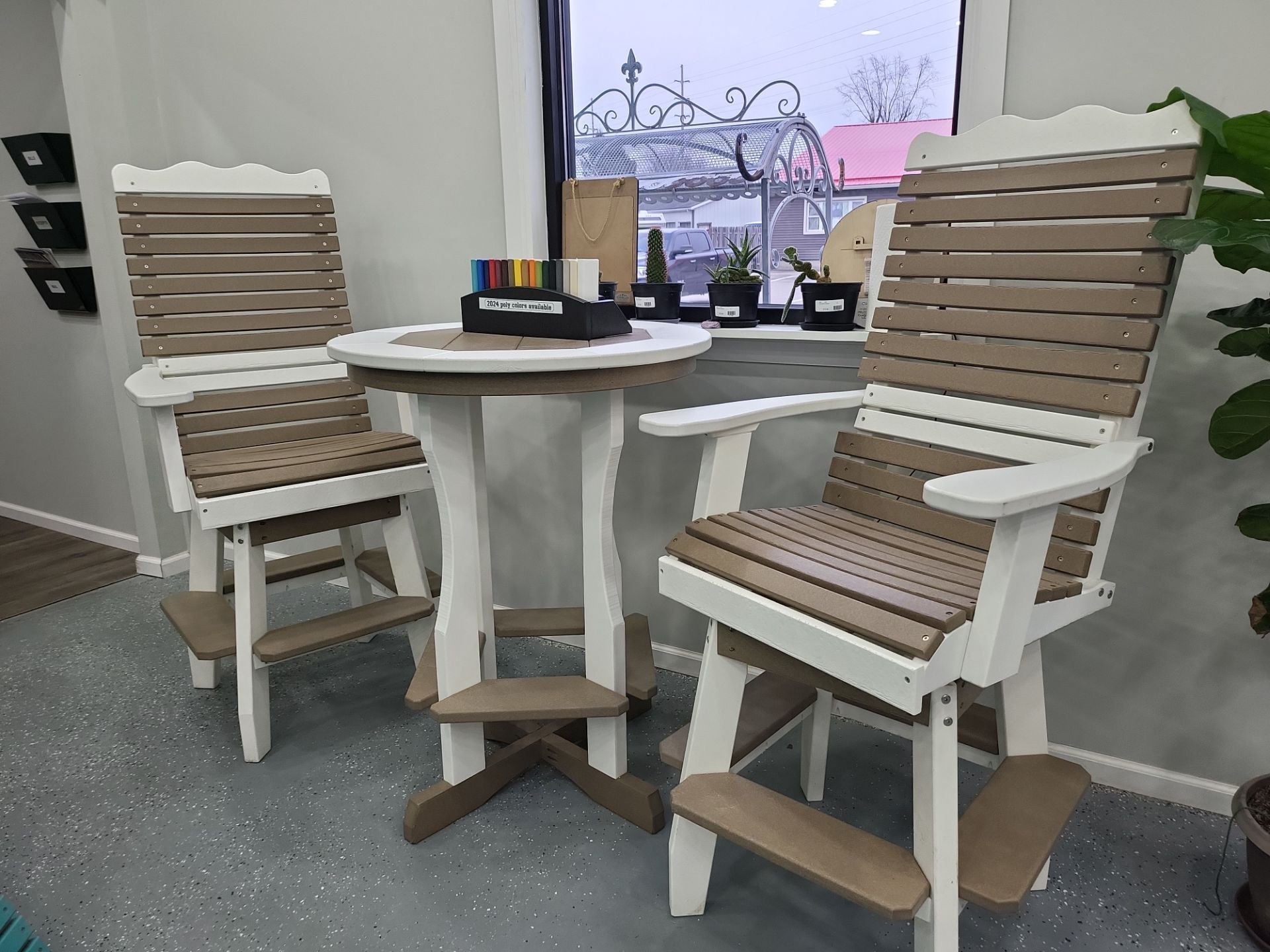 A table and chairs are sitting in front of a window in a room.
