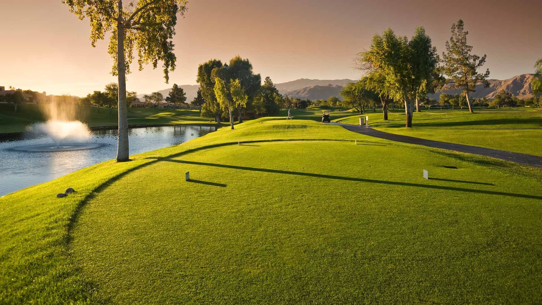 A golf course with a fountain in the middle of it