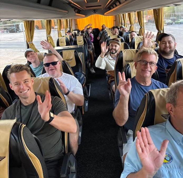 Coach bus full of pastors traveling through Israel waving toward the camera