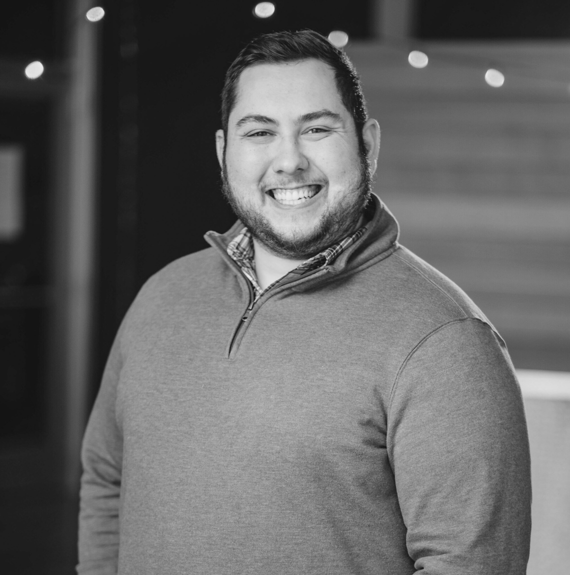 Black-and-white profile portrait of Pastor Tim smiling at the camera