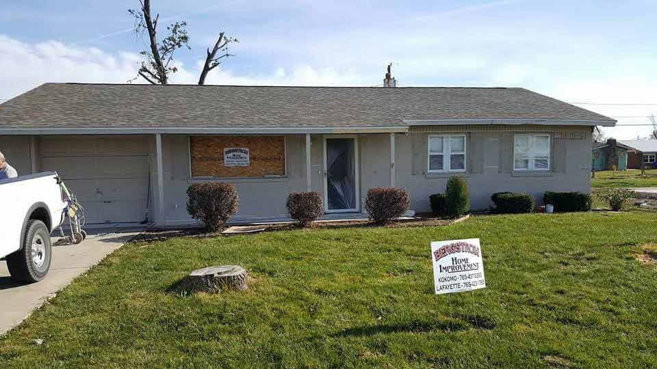 Single-story house with a front lawn and a real estate sign in the yard