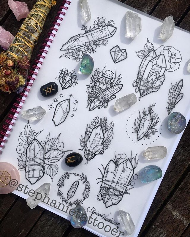 A notebook with drawings of crystals and feathers by stephanie tattooer