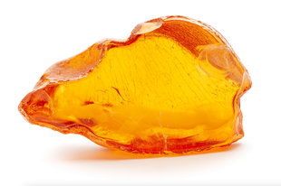 A close up of a piece of amber on a white background.