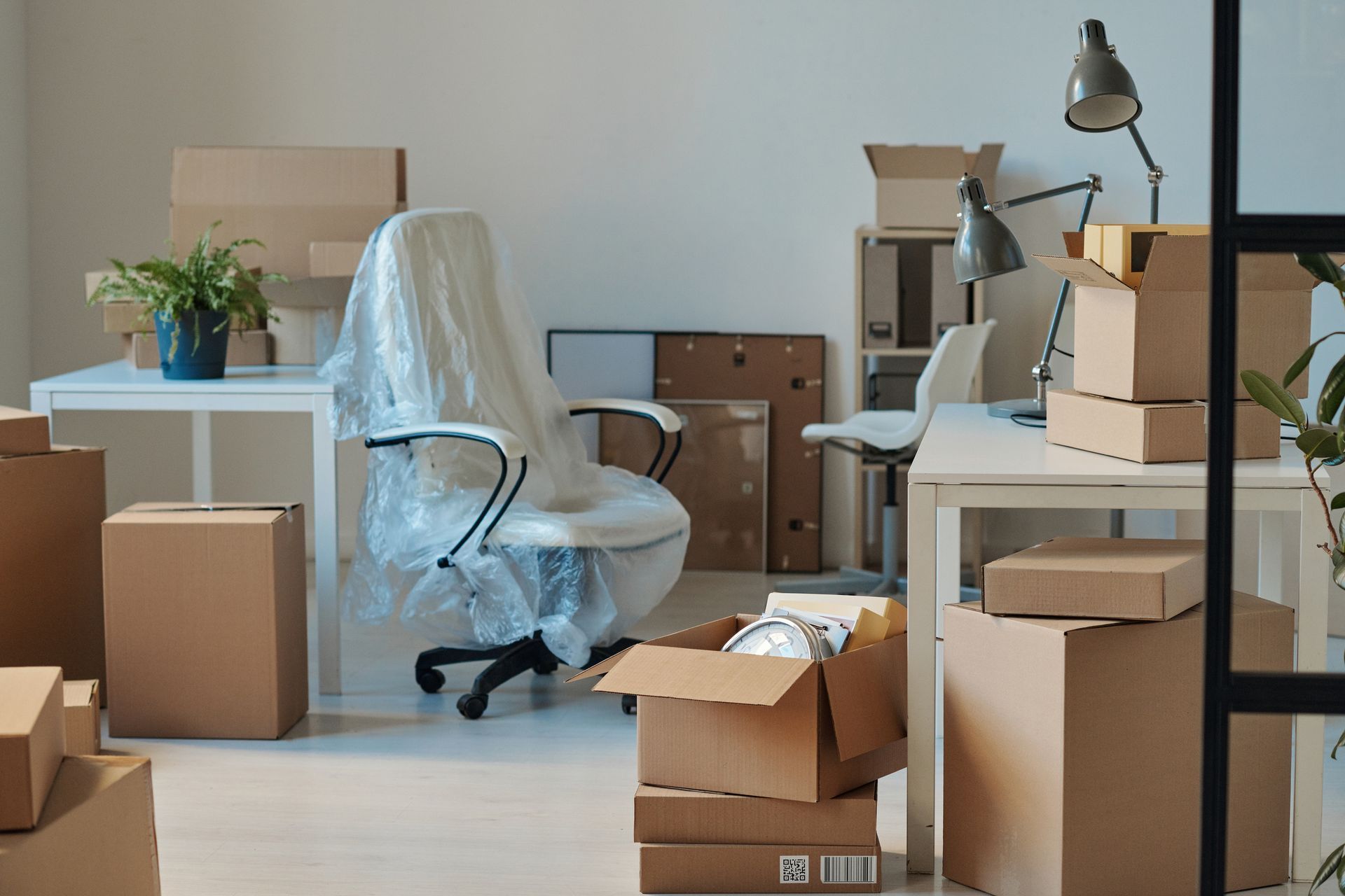 An office full of boxes and new furniture.