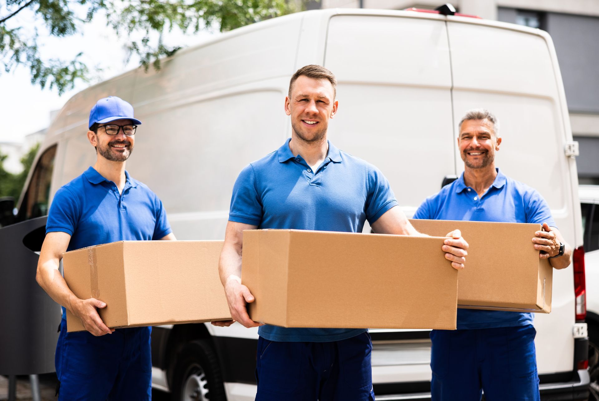 Professional movers loading a van with boxes.