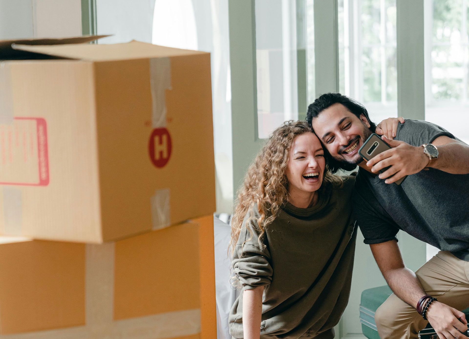 First-time home owner taking selfie while moving in