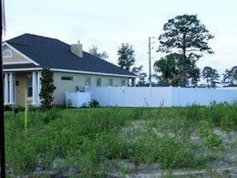 A house with a white fence in front of it