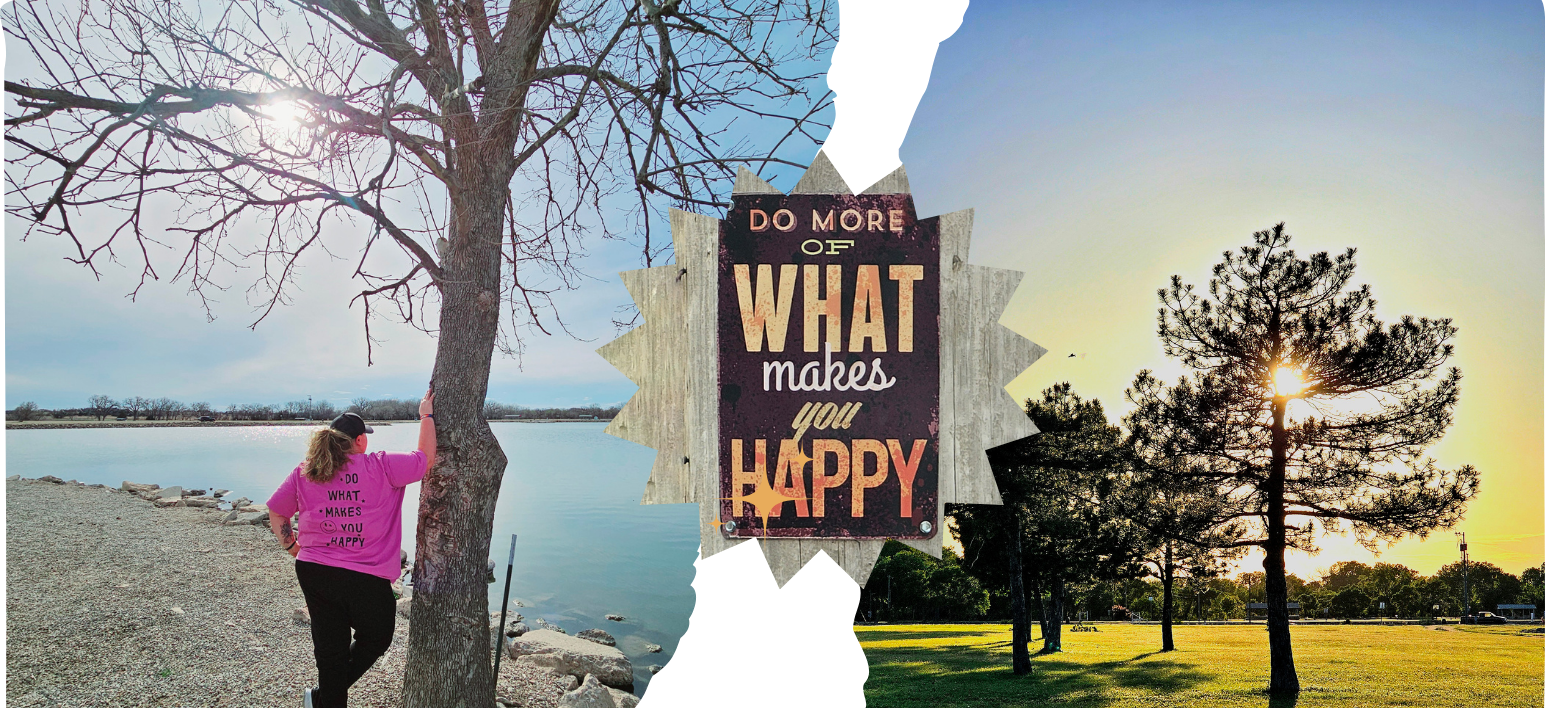 Person in pink jacket by a lakeside tree, with a sunset sign reading “What makes you happy?”