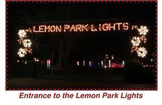 Night entrance sign reading “LEMON PARK LIGHTS” framed by glowing holiday decorations