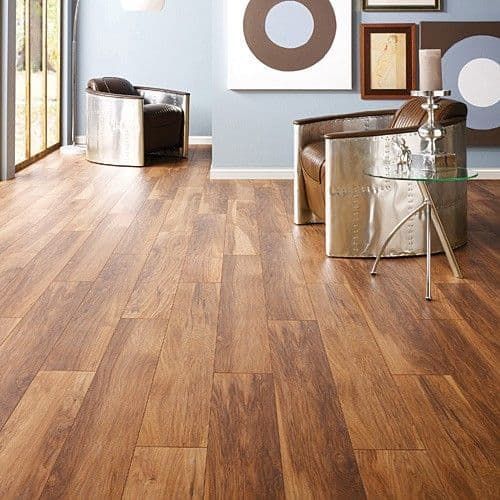 Hardwood floor in room with two silver chairs and artwork.