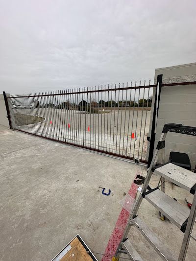 A man is using a calculator and stacking coins on a table.