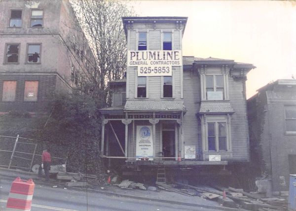A plumline sign is on the side of a building