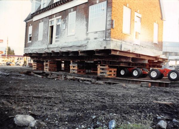A large house is being moved to a new location