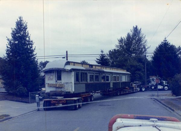 A house is being moved down a street by a truck