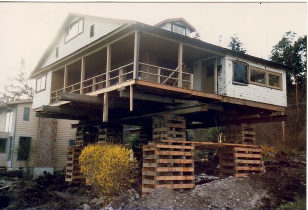A house is being moved on wooden pallets