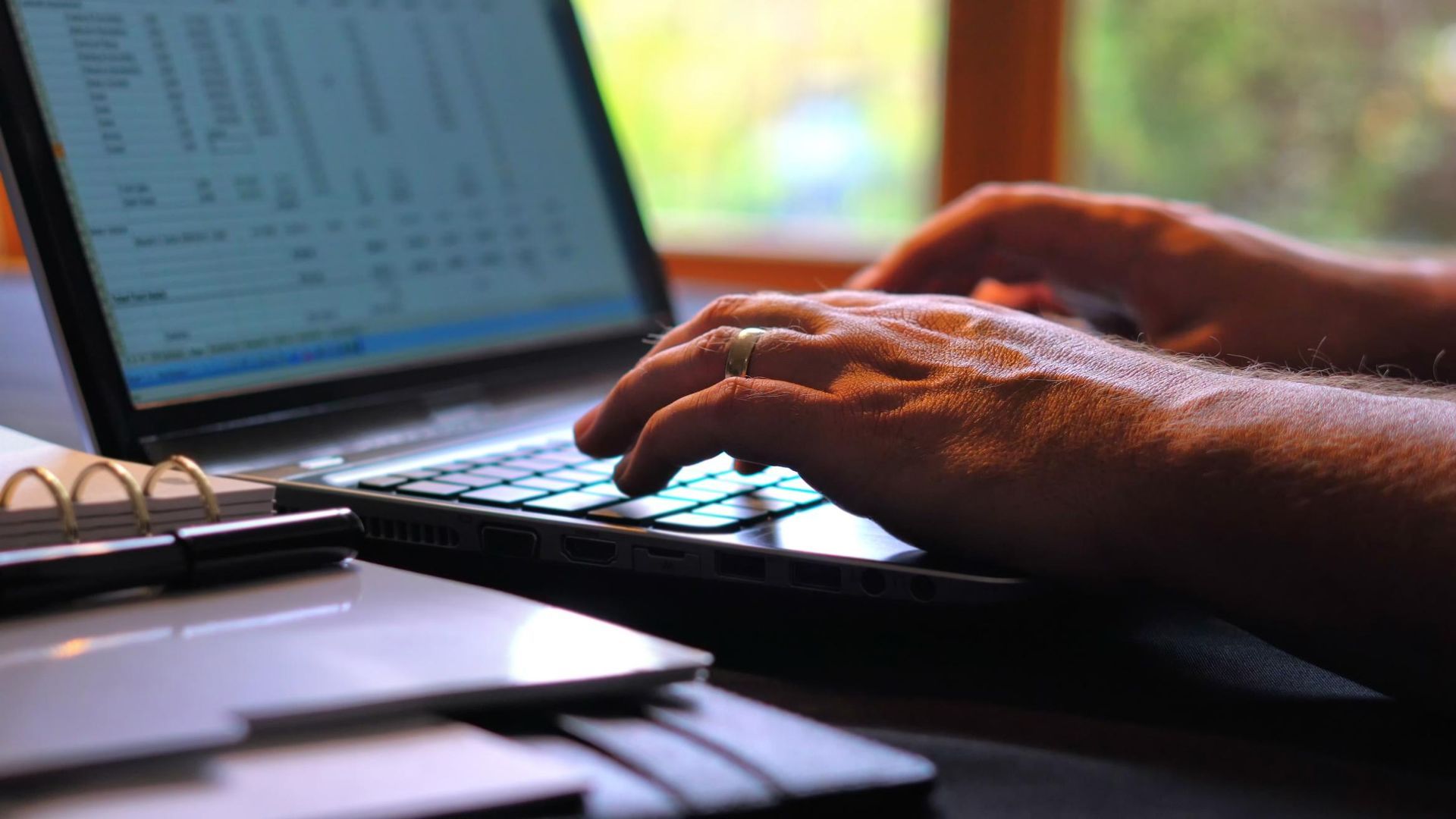 A Person is Typing on a Laptop Computer — River City Communications In Forster, NSW