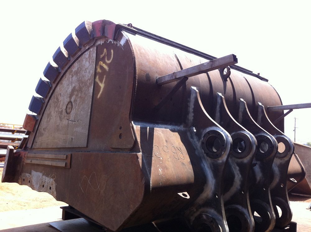 Three Men Workers Unloading The Big Bucket From The Truck — Wright's Welding Operations In Cloncurry, QLD