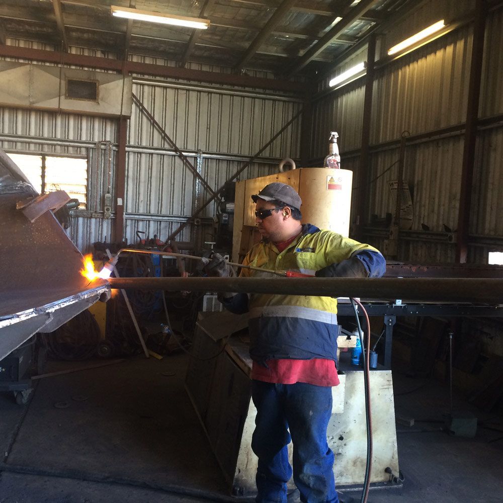 Male Worker Cutting The Metal Using Acetylene — Wright's Welding Operations In Camooweal, QLD