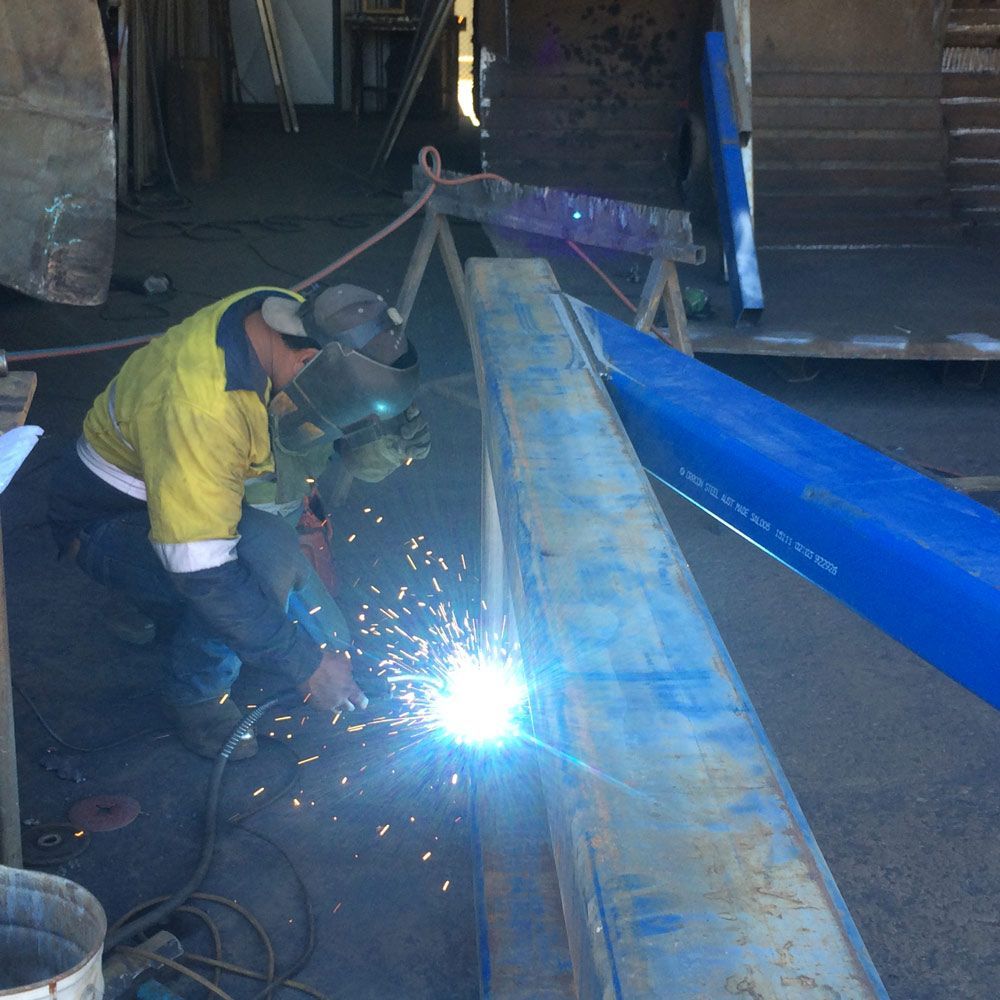 Men Worker Welding Heavy Metal And Wearing Protective Mask — Wright's Welding Operations In Karumba, QLD