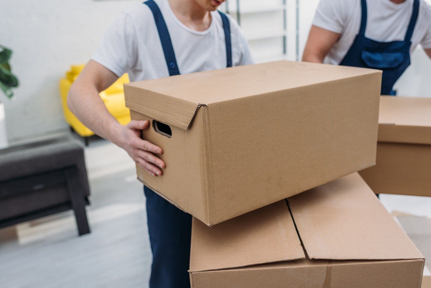 A Movers Carrying Cardboard Boxes Inside a Room — The Cheapy Shop in Old Bar, NSW