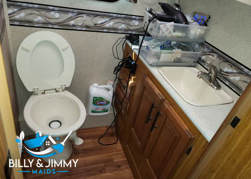 a bathroom with a toilet a sink and a sign that says billy & jimmy maids