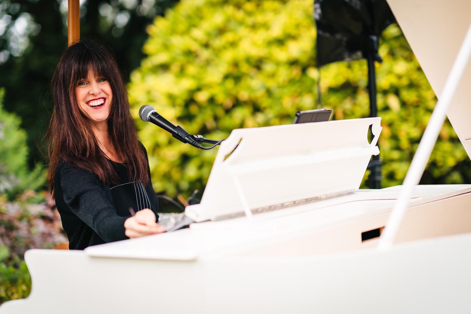 Vanessa Hastings performing during a wedding reception outside