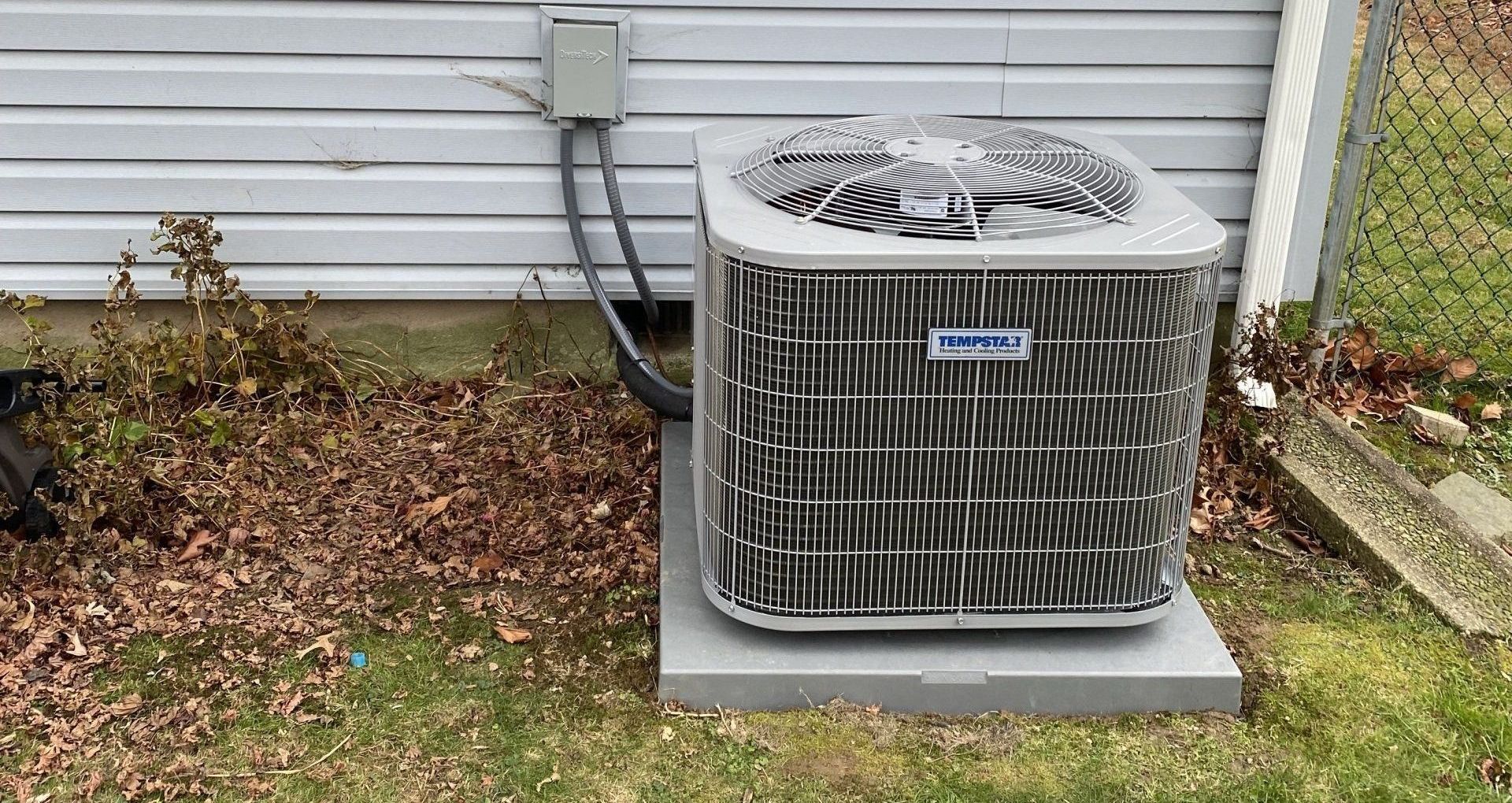 A large air conditioner outside the house.